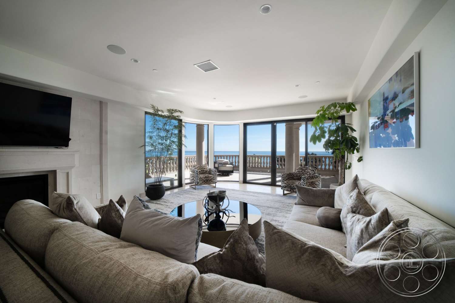 Medit 169 - neutral color palette, exterior, open floor plan, glass coffee table, textured wall finish, concrete walls, floor-to-ceiling windows, soft area rug, coastal view, built-in fireplace, potted indoor plants, light-colored fabric sofa, natural light flooding living space, modern gallery art, distinctive balcony railings
