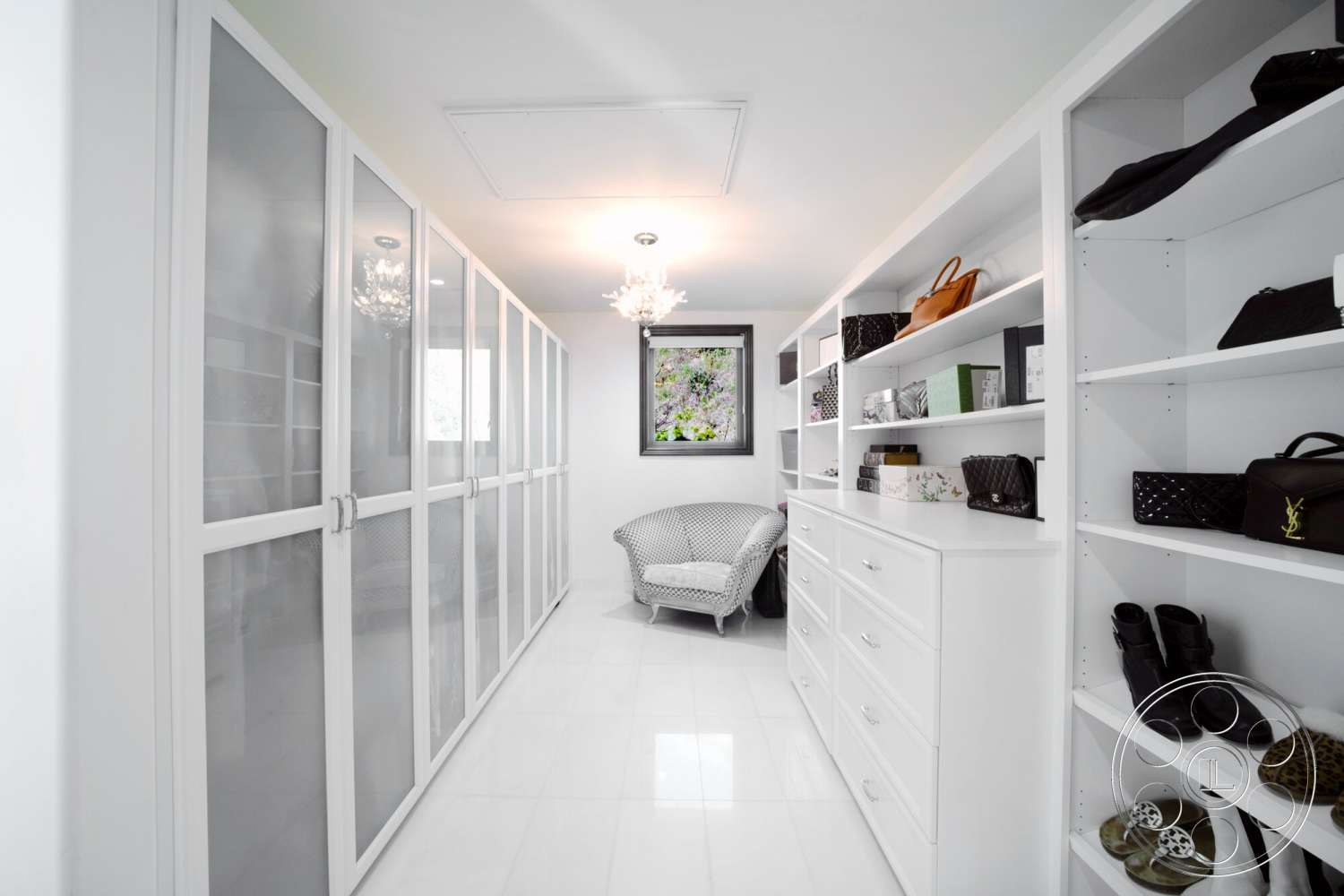Medit 169 - minimalist decor, modern design, glass sliding doors, chandelier lighting, cozy sitting area, large window view, glossy tile flooring, white painted walls, mirrored accents, built-in white shelving units