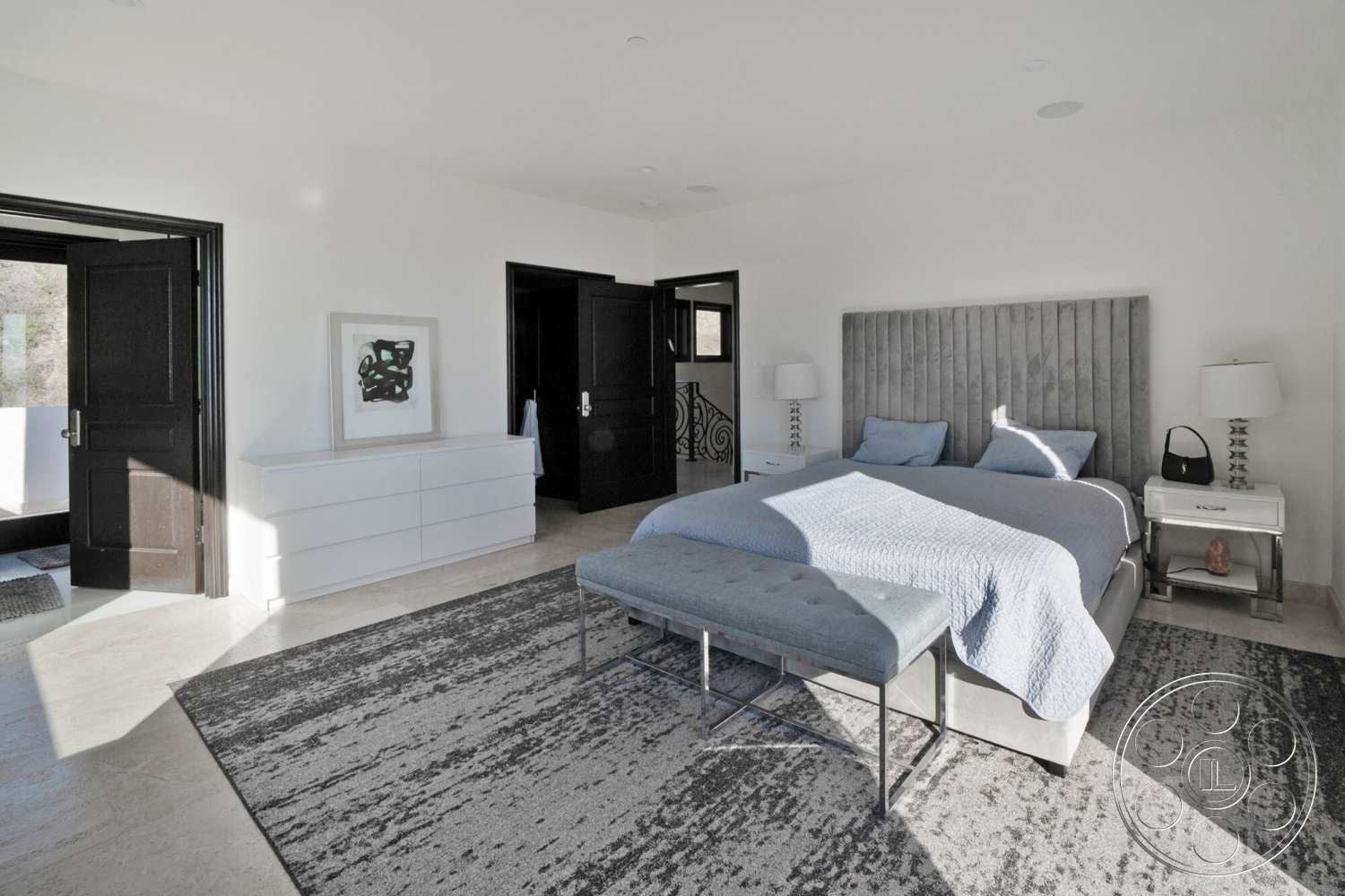 Medit 169 - neutral color palette, floor-to-ceiling windows, textured plaster walls, dark wood paneling, flush ceiling lights, black double doors, queen-size upholstered bed, contemporary bedside tables, framed abstract wall art, marble bedroom flooring, gray upholstered bench, sleek dresser unit