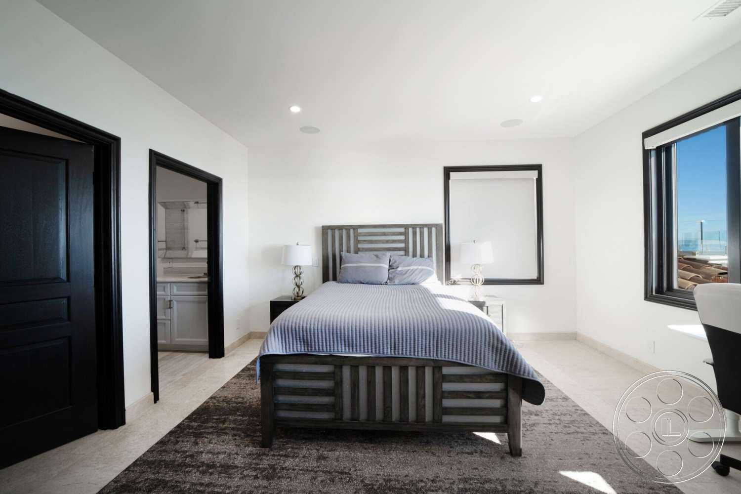 Medit 169 - neutral color palette, stone tile flooring, hardwood bedroom floors, white painted walls, large windows with black frames, minimalist bedroom design, modern bedside lamp, black interior doors, gray upholstered bed frame
