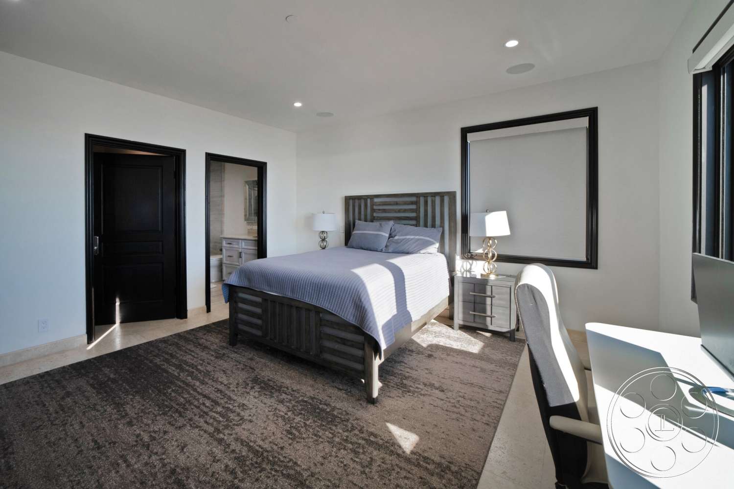 Medit 169 - neutral color palette, natural light, spacious layout, minimalist aesthetic, light-colored walls, floor-to-ceiling windows, wooden bed frame, metal bedside lamp, interior bedroom, glass window treatments, contemporary bedroom design, textured area rug flooring, dark wood paneling doors, queen-sized bed with gray bedding, modern desk with ergonomic chair