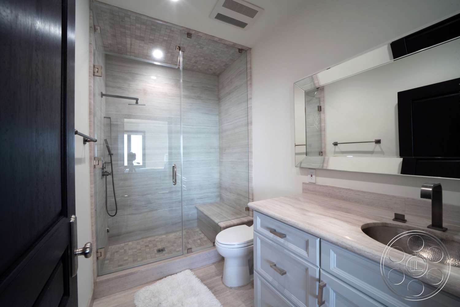 Medit 169 - rectangular mirror, modern faucet, recessed ceiling lights, glass shower doors, dark wood bathroom door, marble shower walls, textured ceiling tiles, tile shower floor, concrete vanity countertop, white shaker style bathroom cabinets, plush white bath rug