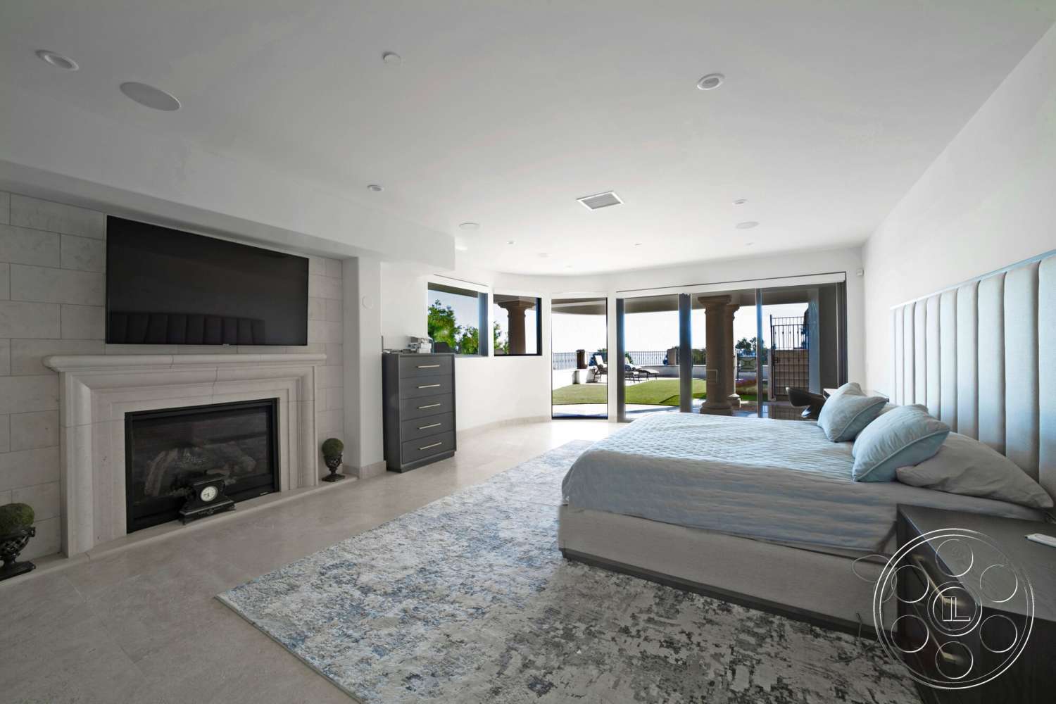 Medit 169 - minimalist design, modern aesthetic, floor-to-ceiling windows, soft area rug, plush upholstered headboard, dark wood dresser, large sliding glass doors, interior bedroom, marble fireplace surround, light-colored wall tiles, view of landscaped exterior