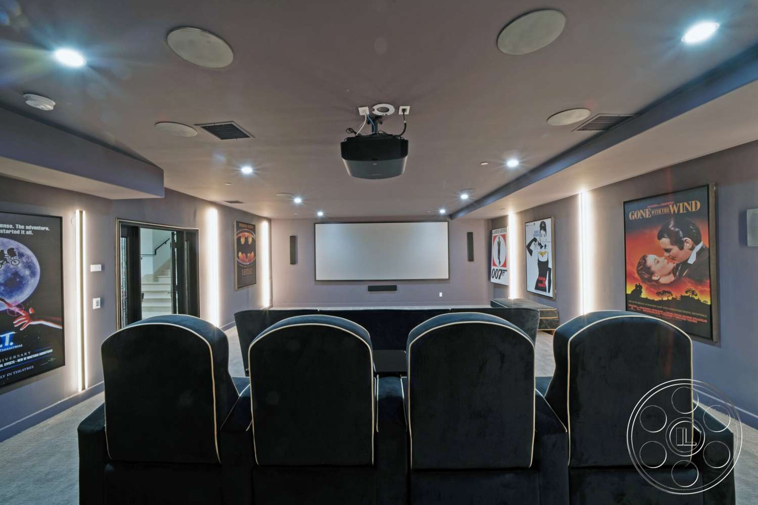 Medit 169 - carpet flooring, large projection screen, ceiling-mounted projector, recessed lighting fixtures, acoustic wall panels, ambient LED strip lighting, home theater room, dark gray textured walls, black velvet theater seating, movie poster wall decor