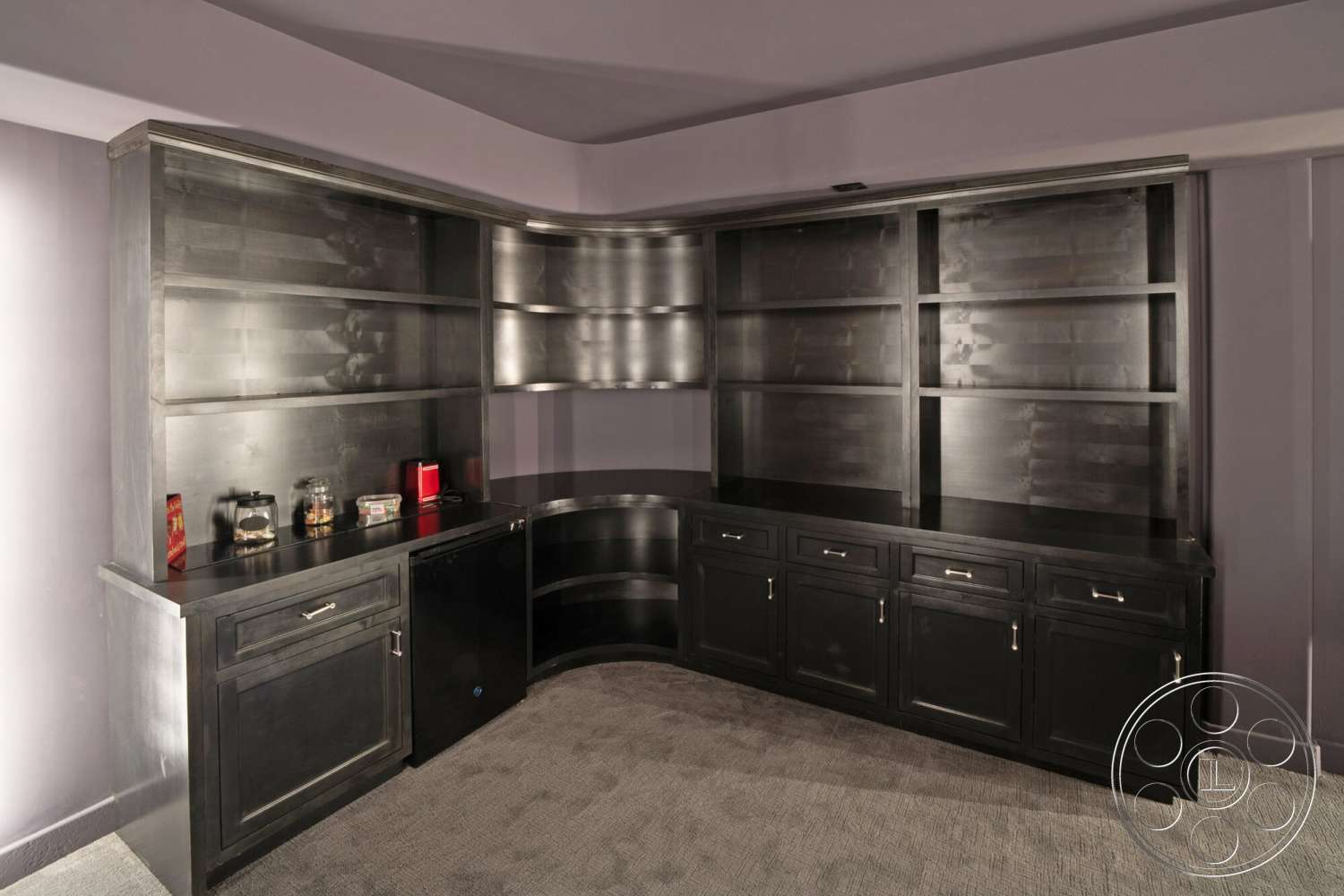 Medit 169 - contemporary design, minimalist aesthetic, carpet flooring, black cabinetry with brushed metal handles, rounded corner built-in shelves, curved countertop, modern home office area