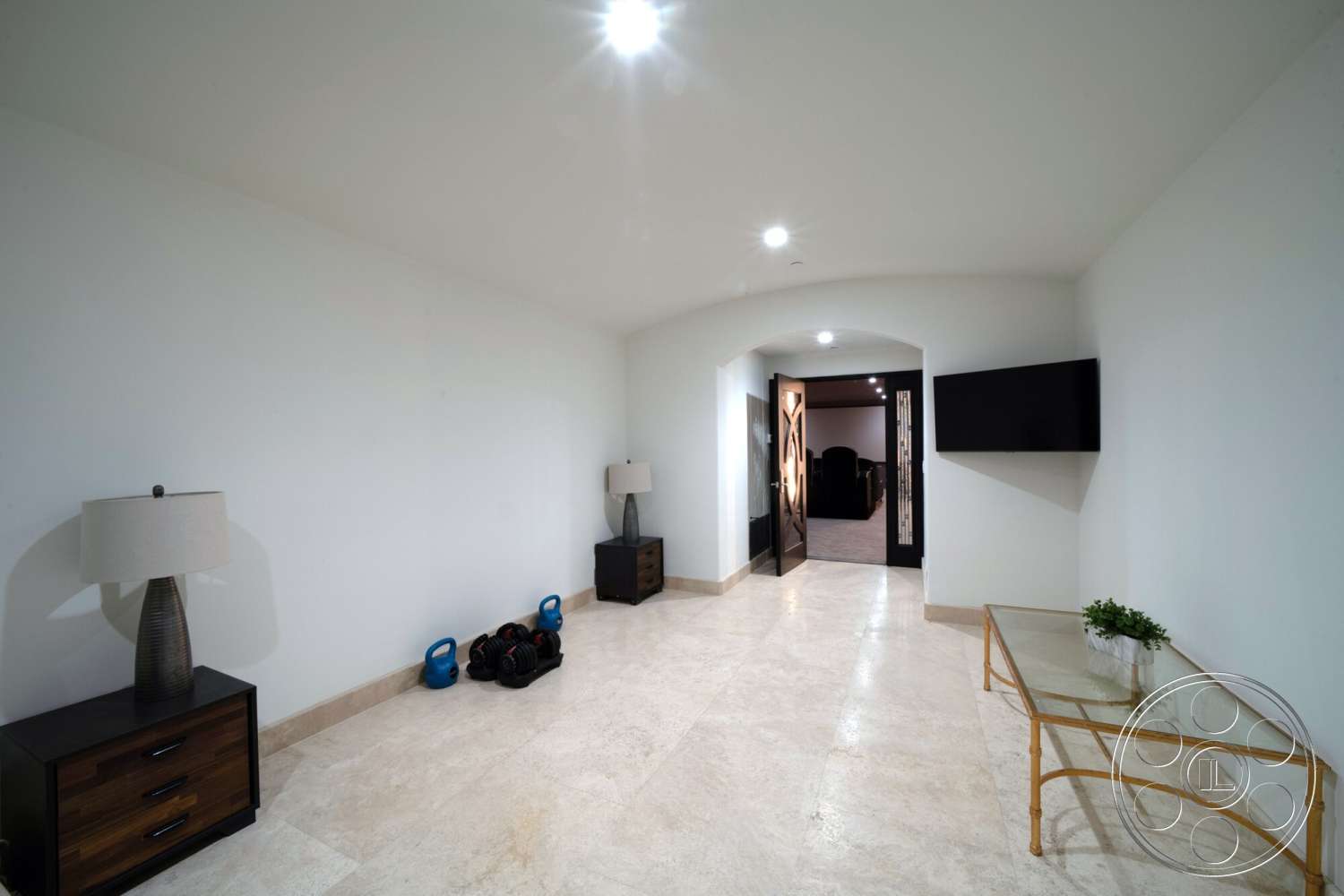 Medit 169 - minimalist design, modern lighting fixtures, polished stone flooring, arched doorways, white painted walls, flat-screen television wall mount, glass-top coffee table, dark wood nightstands, functional fitness area