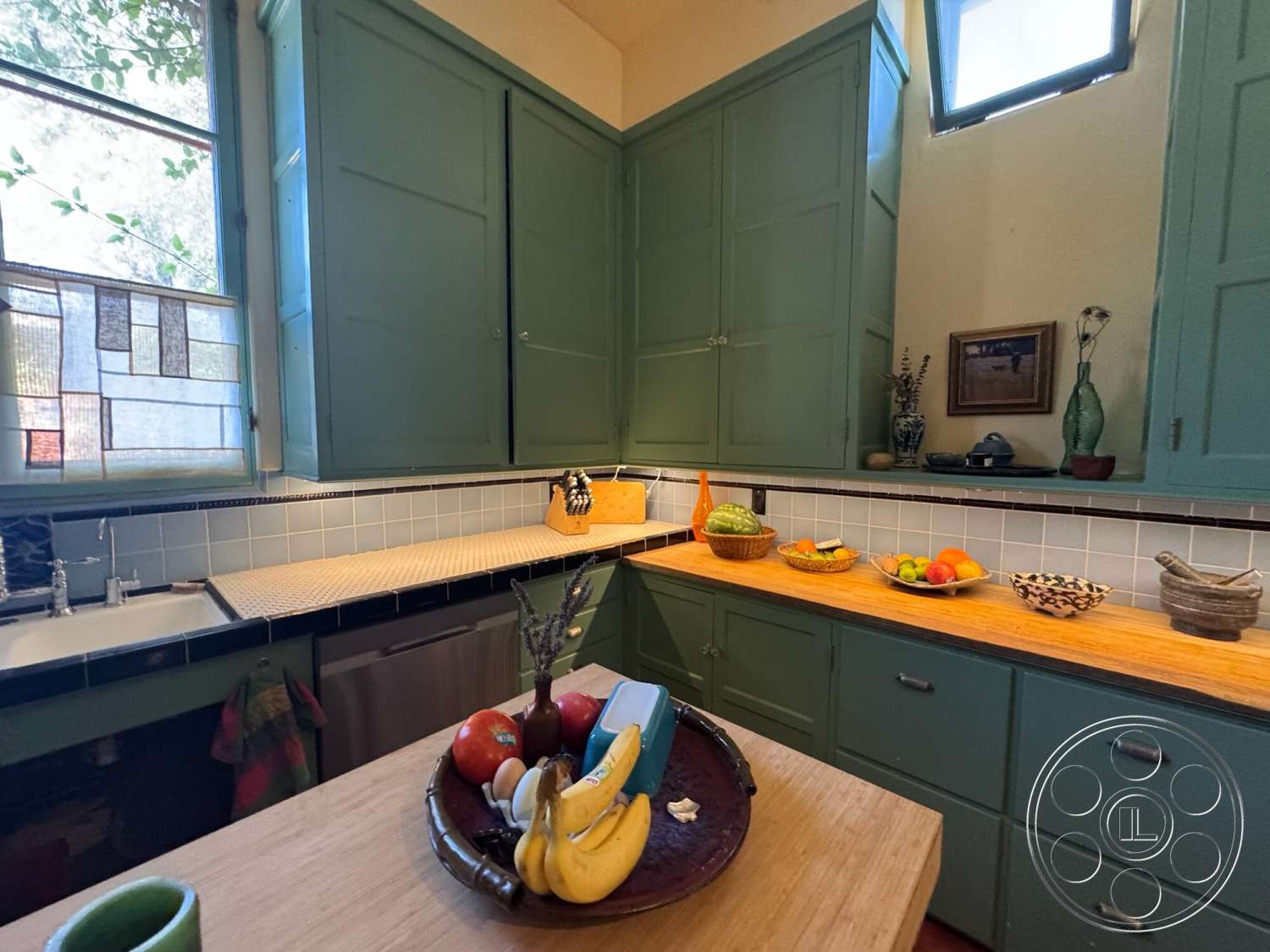 Farmstead Garden - natural light, open shelving, floor-to-ceiling windows, kitchen area, neutral wall color, wood countertop, textured wall treatment, stainless steel sink, functional kitchen, green cabinetry, tile kitchen backsplash, wooden fruit bowl, blue ceramic tile, window with stained glass
