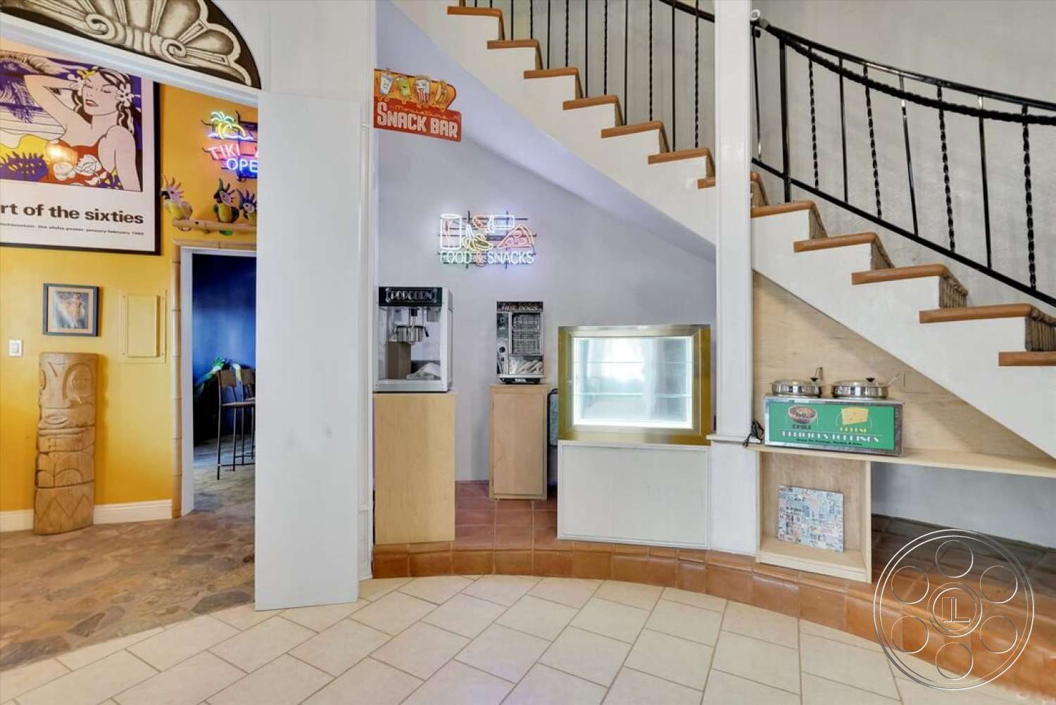 Spanish 170 - neutral color palette, open floor plan, colorful wall art, ceramic tile flooring, textured plaster walls, decorative accent wall, curved entryway design, exposed wood staircase with metal railings, rounded snack bar area