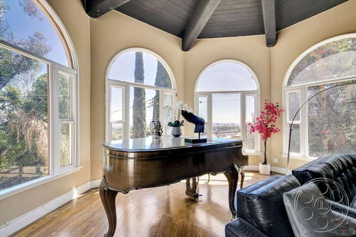 Spanish 170 - hardwood flooring, contemporary furniture, arched windows, painted walls, black wood beam ceiling, interior living room, indoor plants as decor, large windows providing natural light, piano in living area