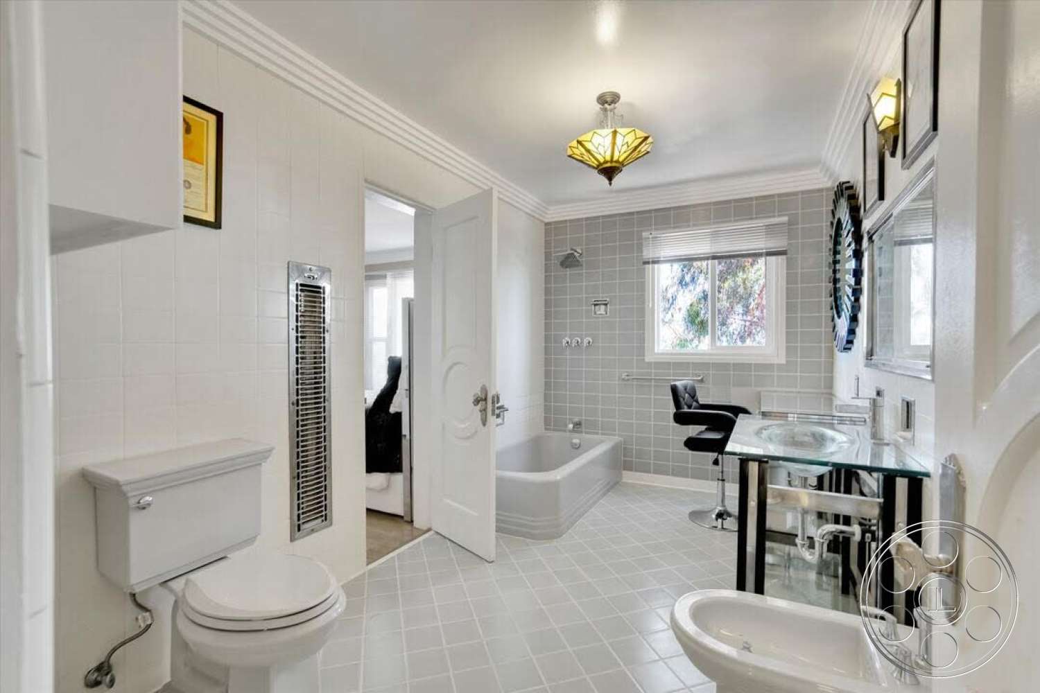 Spanish 170 - freestanding bathtub, ceramic tile flooring, contemporary chair, framed wall art, floor-to-ceiling window, modern light fixture, white painted walls, chrome bathroom fixtures, gray tile bathroom walls, glass-top vanity, built-in heater