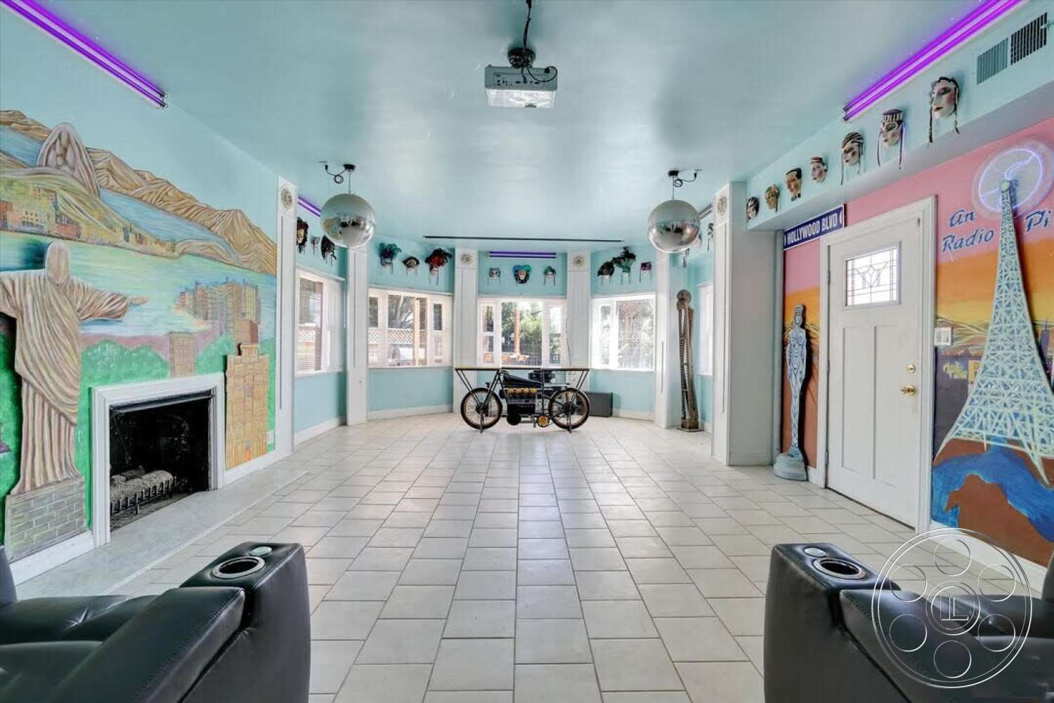 Spanish 170 - large windows, tile flooring, exterior, open space layout, ambient lighting, built-in fireplace, modern door design, rectangular room layout, light blue painted walls, decorative mural wall art, disco ball ceiling fixture, themed interior decor, recliner seating