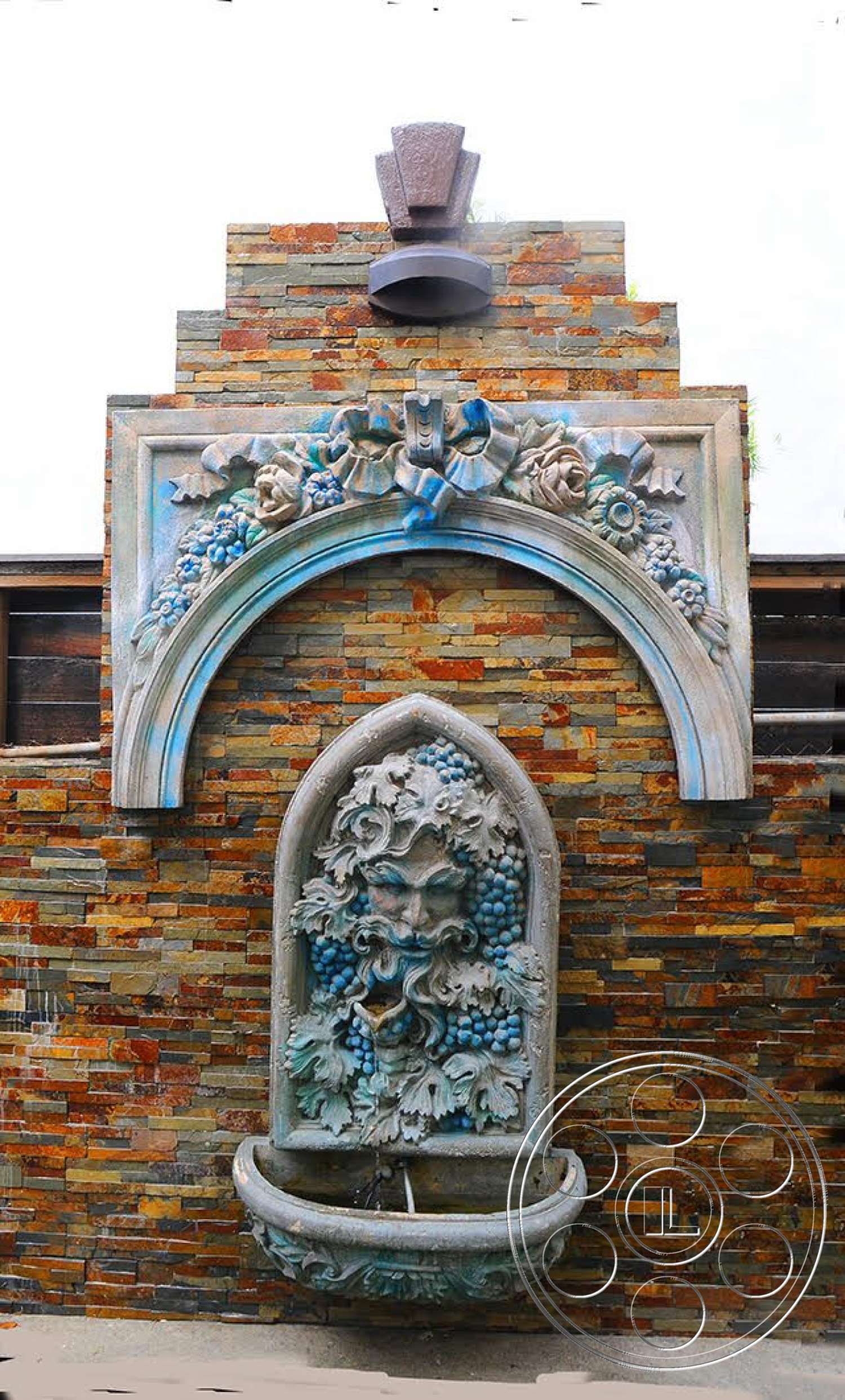 Spanish 170 - exterior, textured wall surface, traditional architectural style, stone feature wall, stacked stone cladding, ornate stone fountain, decorative stone basin, arched fountain design, sculptural relief decoration, floral detailing