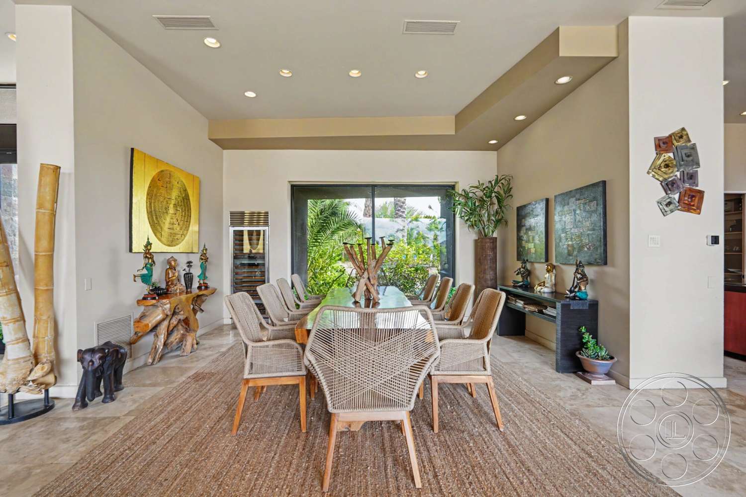 Rancho Mirage 4 - neutral color palette, contemporary design, indoor plants, open floor plan, wood dining table, glass dining table, decorative wall art, marble flooring, textured plaster walls, arched windows, elegant dining area, bamboo accents, woven dining chairs, recessed ceiling lighting