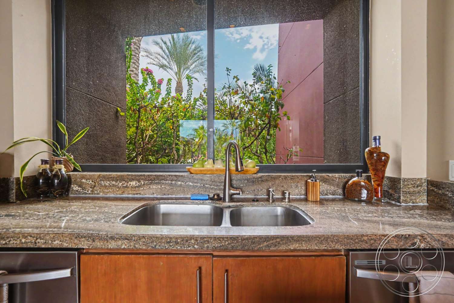 Rancho Mirage 4 - wood cabinetry, floor-to-ceiling windows, lush garden view, modern kitchen design, granite kitchen countertop, interior kitchen, minimalist kitchen decor, stainless steel kitchen sink