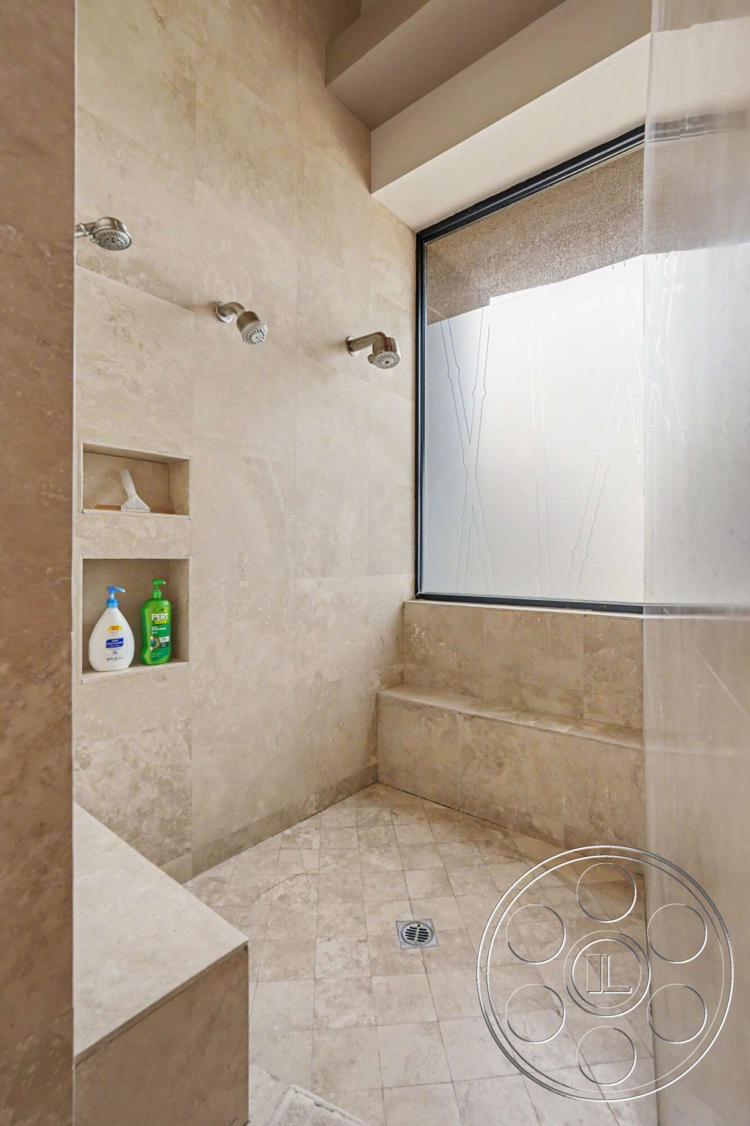 Rancho Mirage 4 - neutral color palette, modern shower fixtures, built-in shower niche, marble shower flooring, stone shower walls, floor-to-ceiling glass window, tiled shower bench, recessed ceiling detail