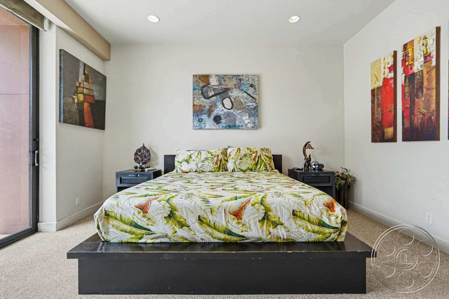 Rancho Mirage 4 - natural light, abstract wall art, modern lamp, floor-to-ceiling windows, black nightstands, textured ceiling, white painted walls, carpet bedroom flooring, wood platform bed