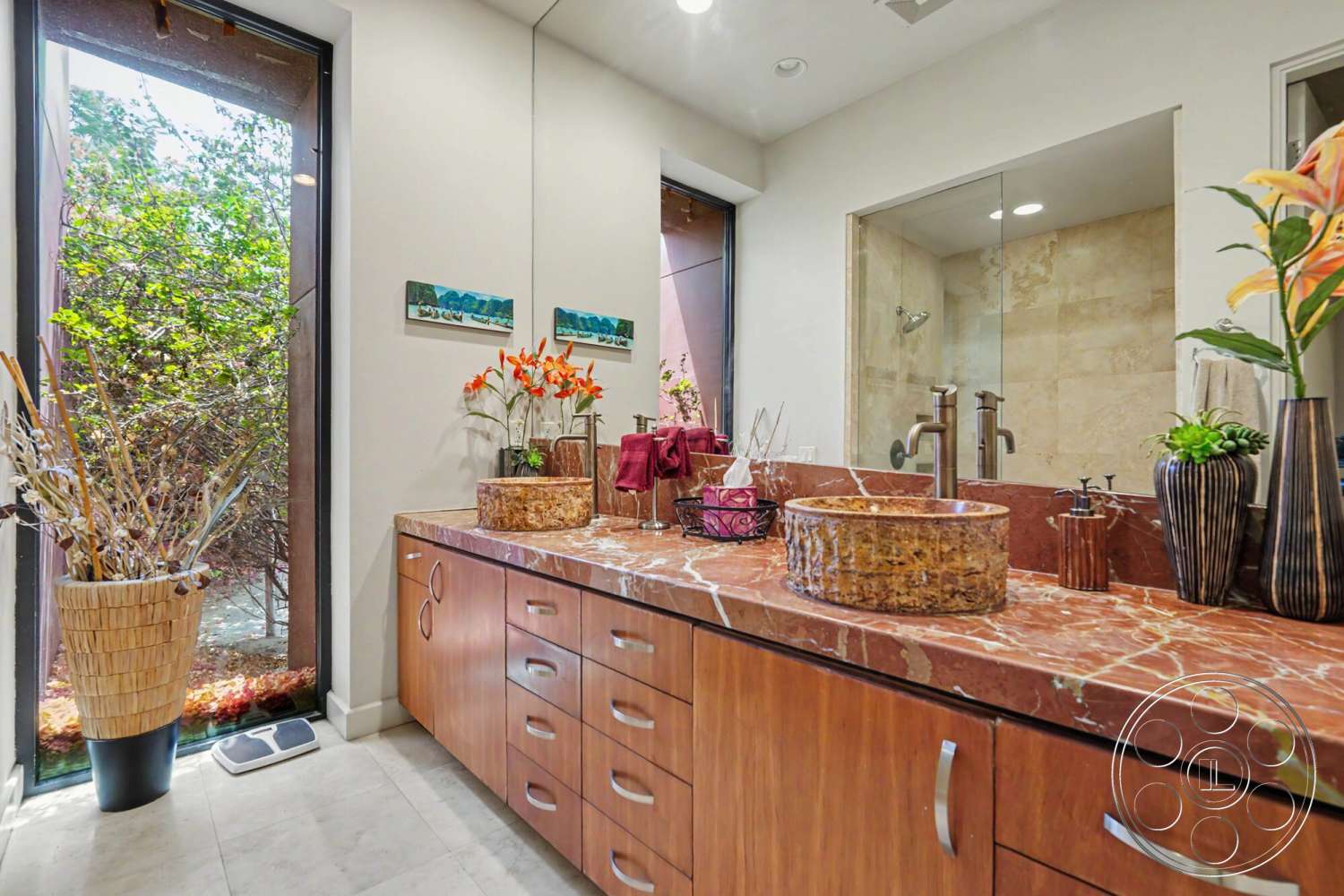 Rancho Mirage 4 - textured stone wall, wood cabinetry, glass shower enclosure, minimalist design elements, ceramic tile flooring, decorative floral arrangements, natural light through large windows, interior bathroom, modern faucet fixtures, marble bathroom countertops, vessel sink