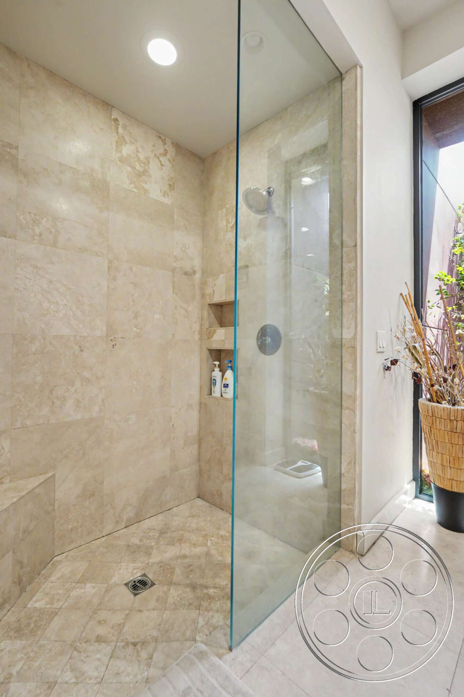 Rancho Mirage 4 - neutral color palette, recessed lighting, contemporary bathroom, built-in shower niche, modern bathroom design, textured tile accents, travertine shower walls, large format tile shower floor, glass shower panel