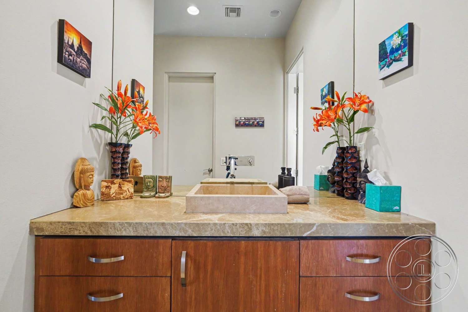 Rancho Mirage 4 - decorative wall art, marble countertop, floral arrangements, modern faucet, neutral painted walls, dark wood vanity cabinets, table decor, under-mount sink, tile floor accent