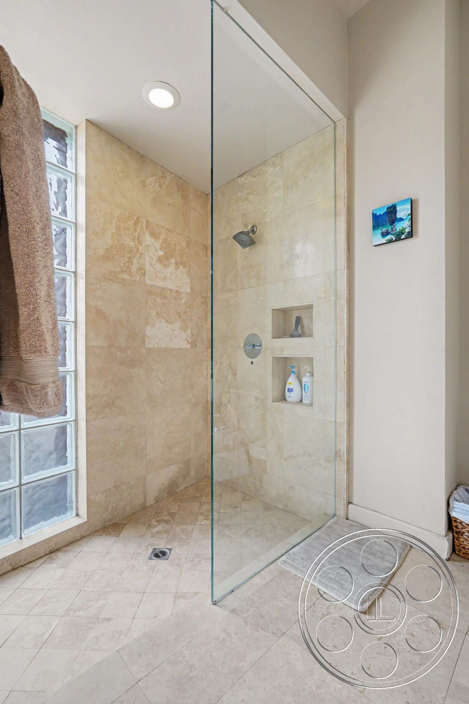 Rancho Mirage 4 - neutral color palette, glass shower doors, recessed lighting fixtures, built-in shower niche, textured bath mat, modern showerhead, stone tile bathroom walls, stone shower flooring, diagonal tile layout