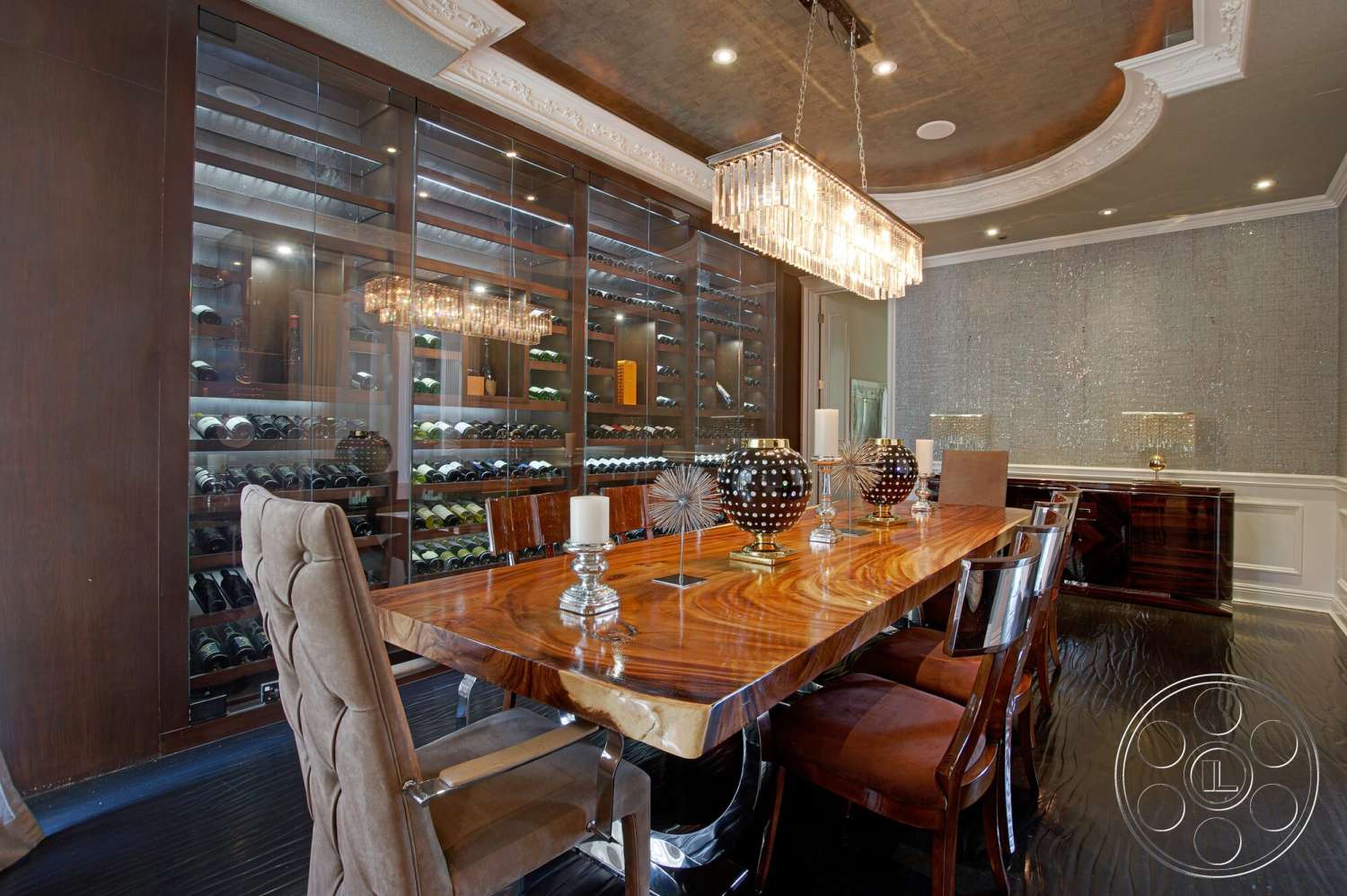 Medit 170 - textured wall finish, dark hardwood flooring, crystal chandelier, dark wood paneling, walnut dining table, metal dining chairs, coffered ceiling details, elegant dining room, glass wine storage unit, decorative table centerpieces