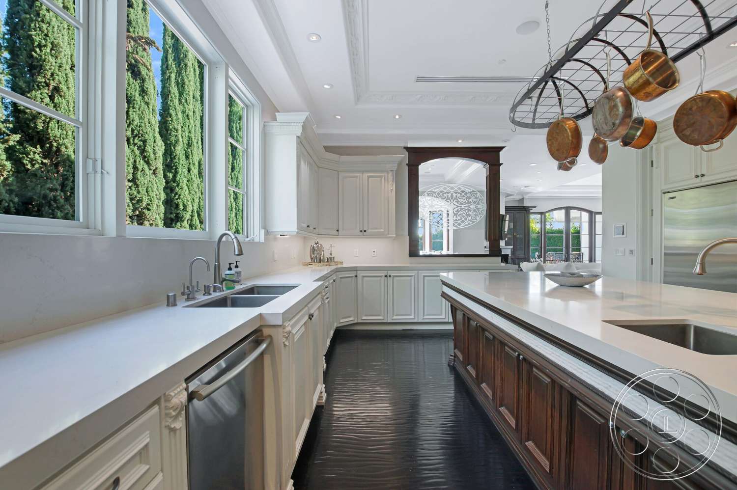Medit 170 - stainless steel appliances, white cabinetry, decorative crown molding, white marble countertop, open-concept layout, dark hardwood kitchen floors, kitchen island with seating, large windows allowing natural light, circular pendant lighting, traditional kitchen style, pantry with built-in cabinets, glass door leading to outdoor area