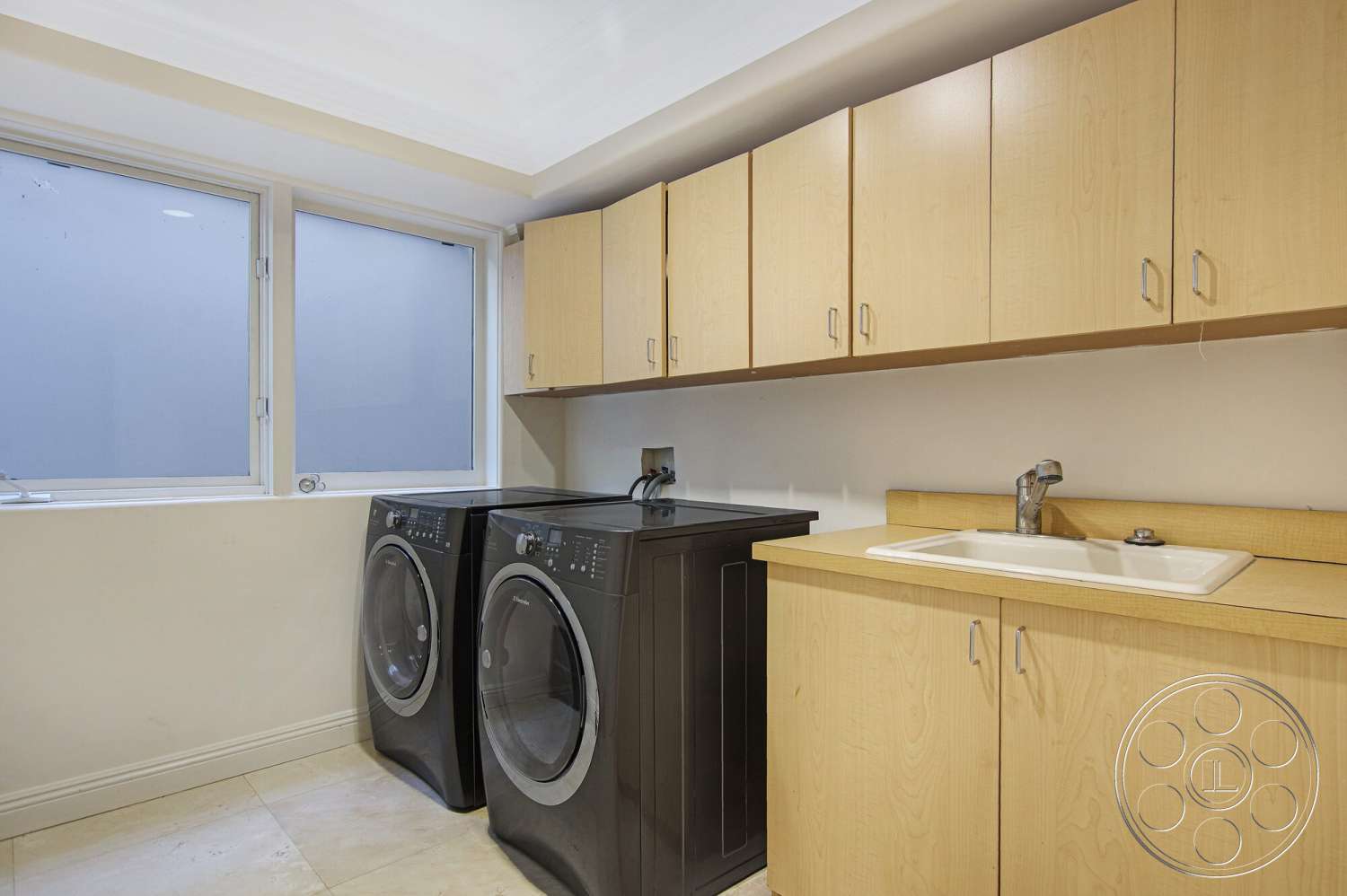 Medit 170 - large windows, stainless steel sink, flat ceiling with recessed lighting, chrome faucet fixtures, interior laundry room, light beige tile flooring, laminate cabinetry, black washing machines