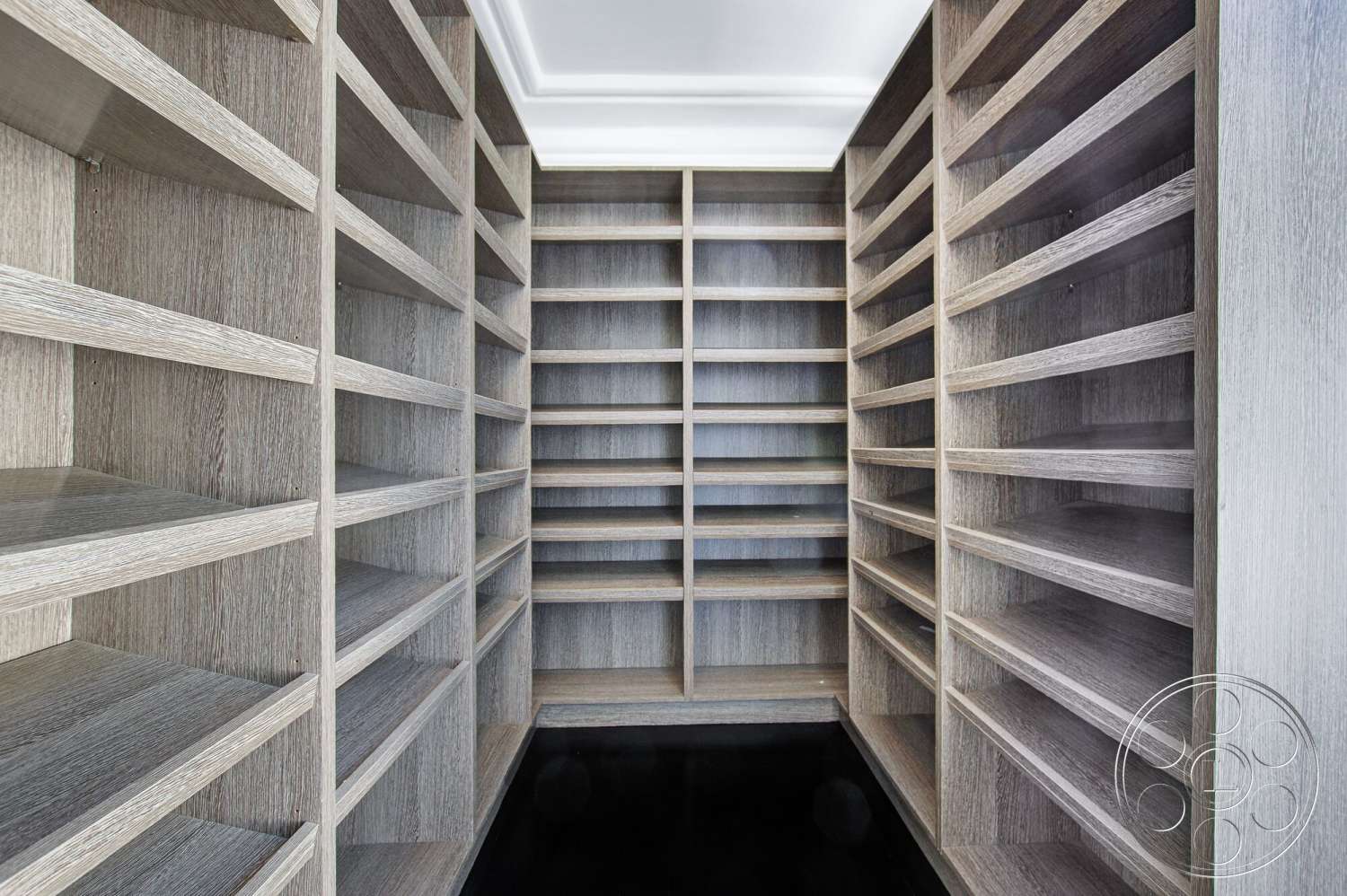 Medit 170 - dark flooring, light wood shelving, textured wood paneling, open shelving unit, organized storage space, minimalist closet design, crisp white ceiling