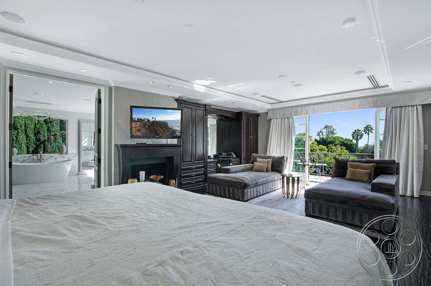 Medit 170 - neutral color palette, glass sliding doors, floor-to-ceiling windows, vaulted ceiling, textured plaster walls, luxurious bedding, hardwood bedroom floors, modern chandelier lighting, built-in wooden cabinetry, palm tree surroundings, outdoor balcony view, stylish decorative pillows, gray velvet chaise lounge, stainless steel fireplace
