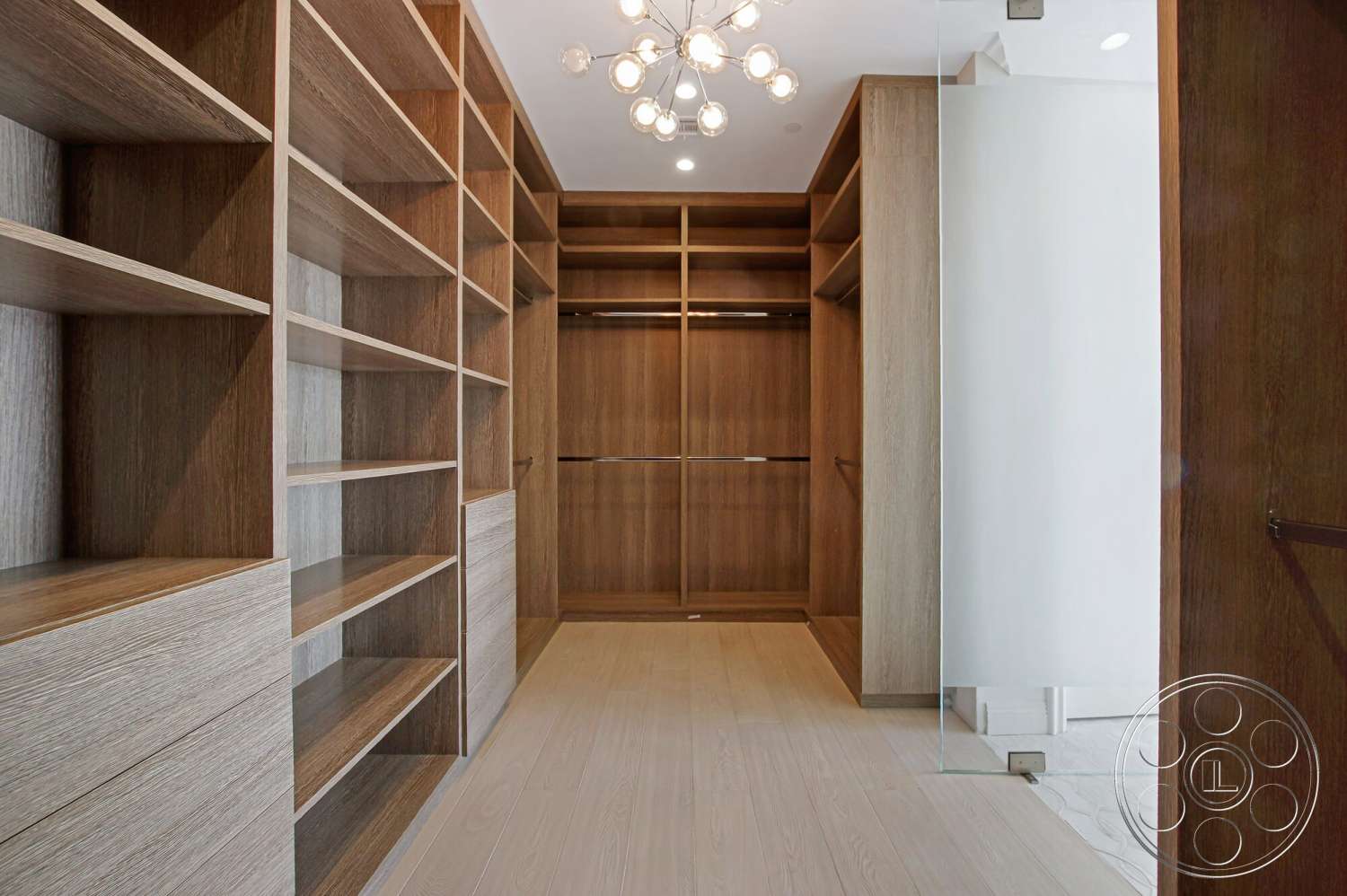 Medit 170 - contemporary style, minimalist design, built-in cabinetry, modern chandelier lighting, glass partition wall, organized storage space, wood shelving units, neutral interior colors, open closet layout, hardwood closet floors
