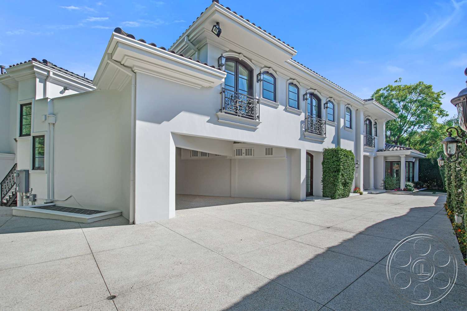 Medit 170 - exterior, flat roof, smooth concrete surface, concrete driveway, gabled roof, symmetrical facade, arched entryway, stucco wall, hedge landscaping, geometric window shapes, modern residential design, decorative outdoor lanterns, ornamental wrought iron railings, driveway approach