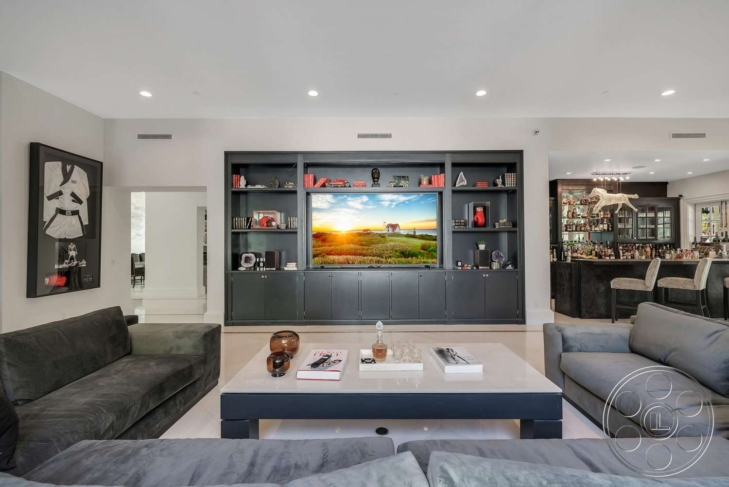 Medit 171 - minimalist decor, artistic wall art, open floor plan, polished marble flooring, large sectional sofa, glass decor accents, contemporary living room, white painted walls, crown molding details, dimensional lighting fixtures, built-in black cabinetry, floor-to-ceiling television unit