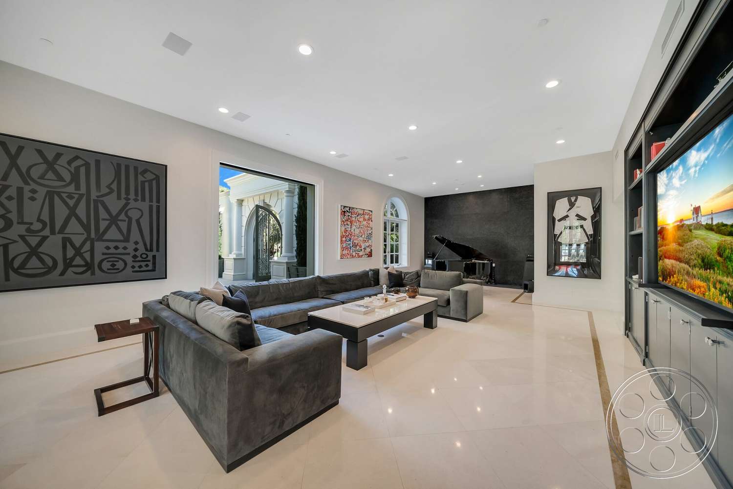 Medit 171 - neutral color palette, wood coffee table, floor-to-ceiling windows, built-in entertainment center, marble flooring, black accent wall, recessed ceiling lights, grand piano, modern living room, gray velvet sectional sofa, framed contemporary art