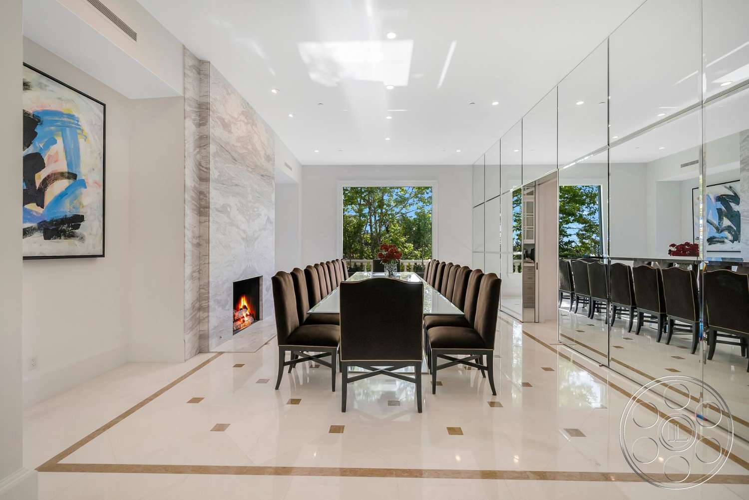 Medit 171 - contemporary artwork, decorative crown molding, rectangular dining table, marble feature wall, large windows with garden view, white painted walls, linear ceiling lighting, modern glass fireplace, mirrored wall panels, black upholstered dining chairs, polished porcelain flooring