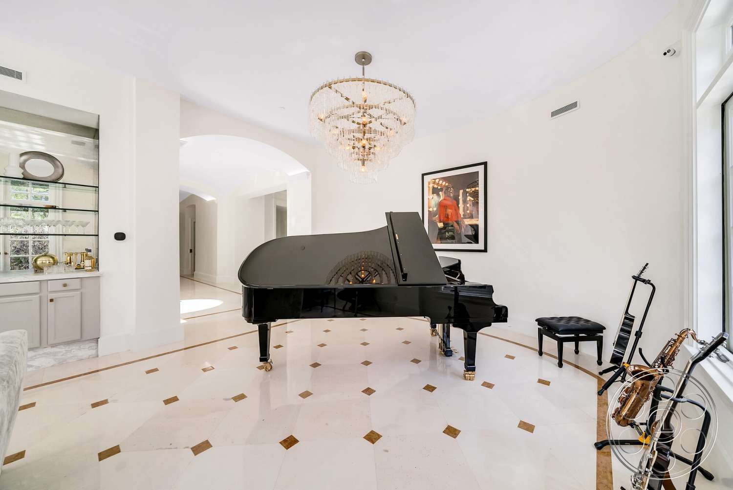 Medit 171 - sliding glass doors, polished marble flooring, curved wall design, white painted walls, gold accents in decor, chandelier with crystal details, rectangular shaped grand piano, built-in glass shelving
