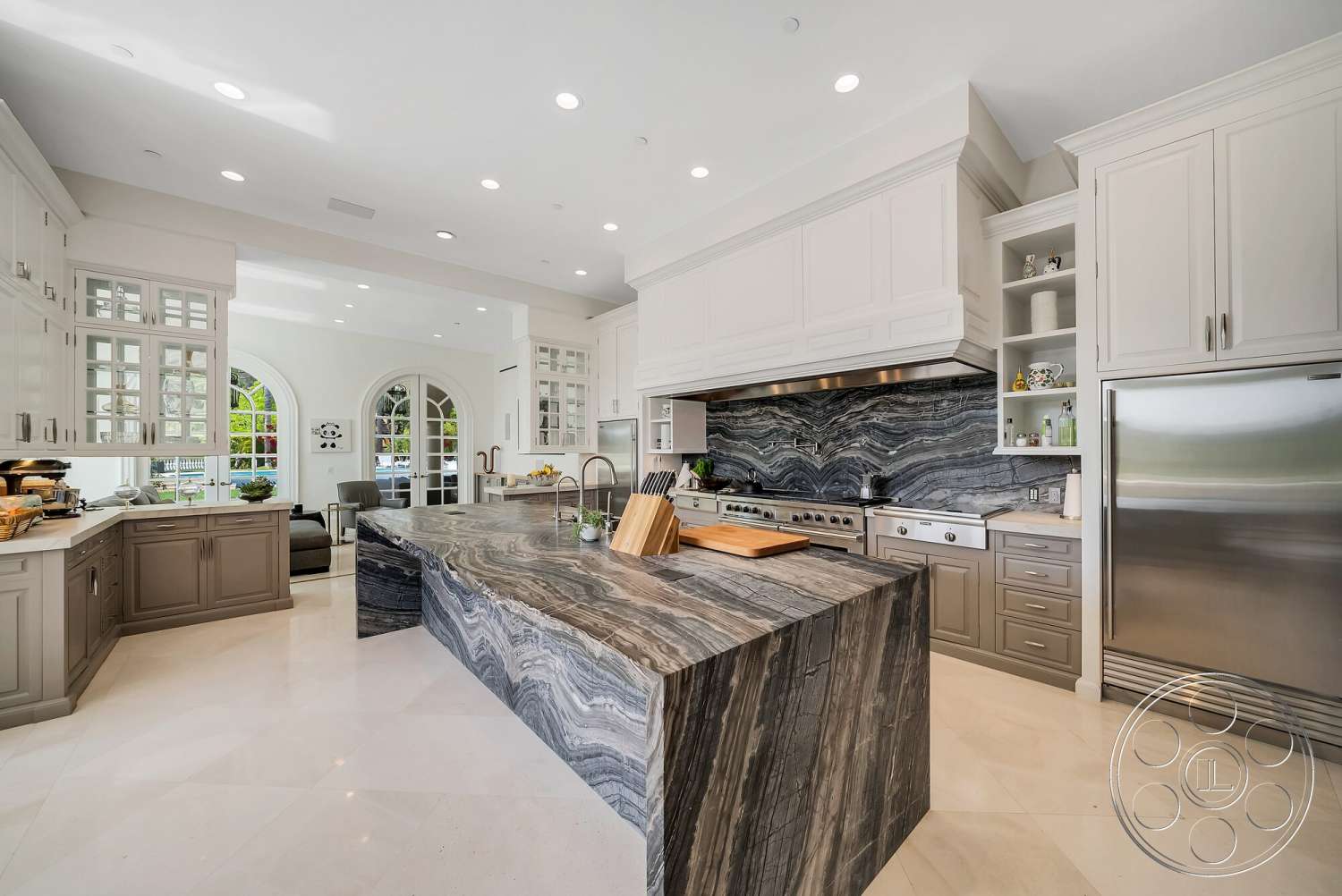 Medit 171 - recessed lighting, open floor plan, stainless steel appliances, white cabinetry, arched doorways, marble backsplash, modern kitchen design, interior kitchen space, built-in kitchen cabinets, neutral tile flooring, granite kitchen island