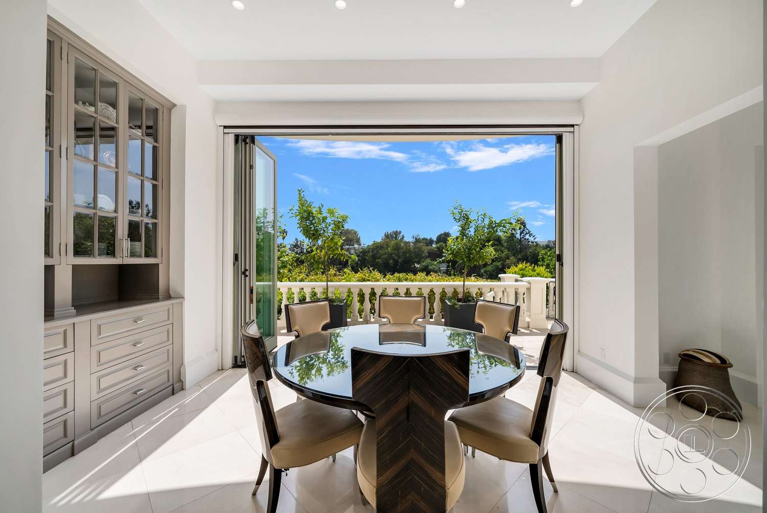 Medit 171 - contemporary design elements, view of outdoor greenery, interior dining area, modern glass dining table, white painted walls, floor-to-ceiling glass sliding doors, light-colored ceramic tile flooring, chevron-patterned wood table, cream-colored upholstered dining chairs, built-in cabinetry with glass doors