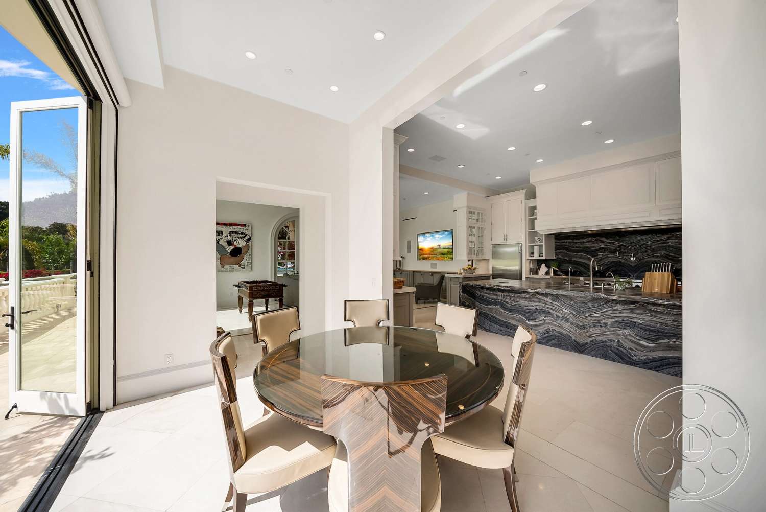 Medit 171 - modern kitchen, natural light, wood dining table, floor-to-ceiling windows, vaulted ceiling, polished tile flooring, breakfast nook, stone feature wall, open-plan layout, contemporary kitchen design, marble kitchen backsplash, white painted walls, glass dining chairs, luxury dining area