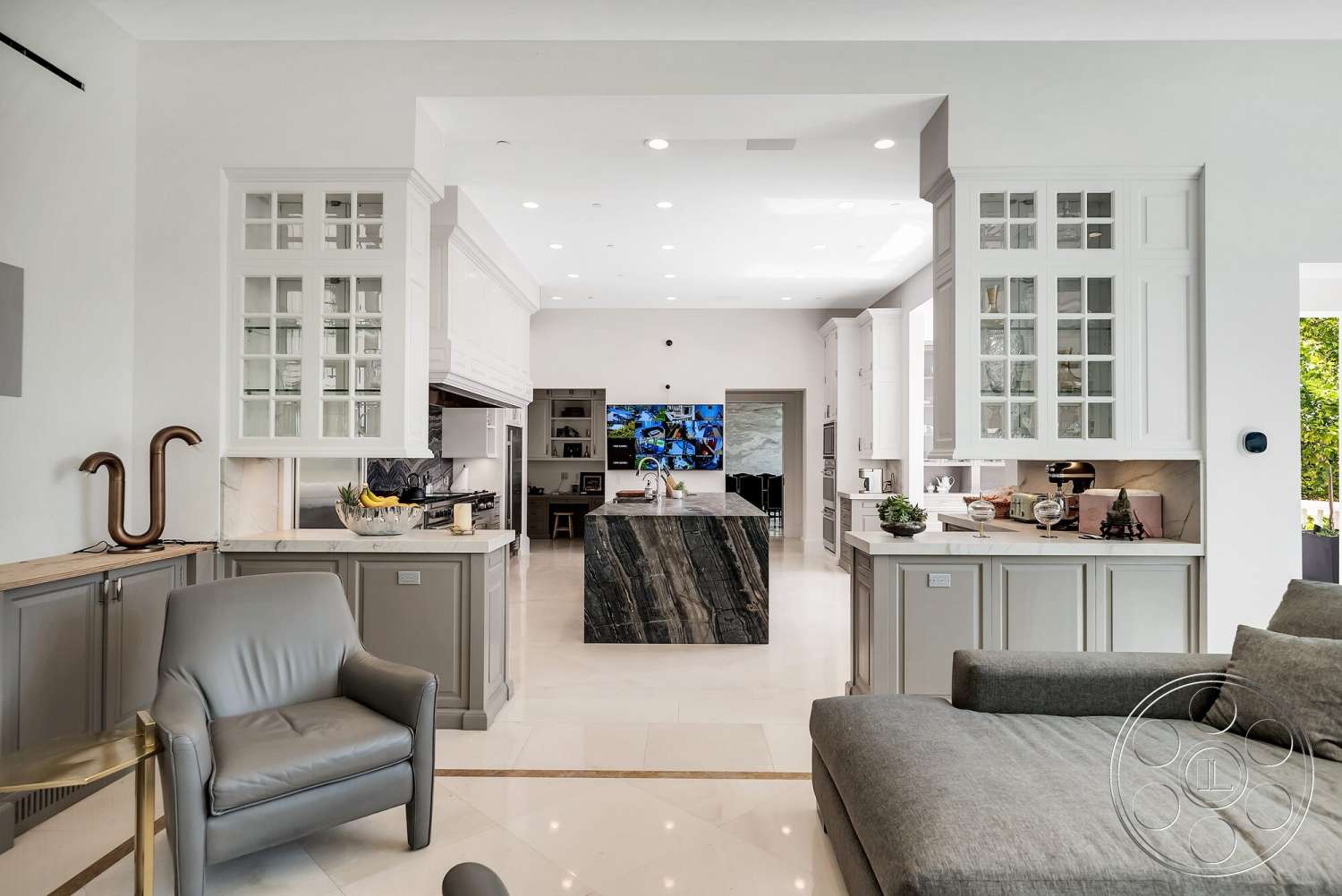 Medit 171 - light-colored walls, open floor plan, modern pendant lighting, vaulted ceiling, stone countertops, under-cabinet lighting, minimalist design aesthetic, marble kitchen island, polished porcelain tile flooring, white cabinetry with glass doors, grey tile backsplash, sleek contemporary furniture, large-format windows