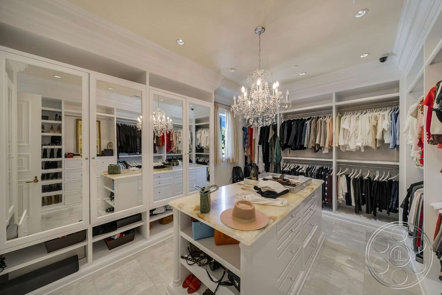 Medit 171 - natural light from window, built-in storage solutions, elegant dressing area, marble countertop island, interior dressing room, white laminate cabinetry, chandelier lighting fixture, customized shelving units, full-length mirrored wardrobe doors, soft beige tile flooring, organized clothing display