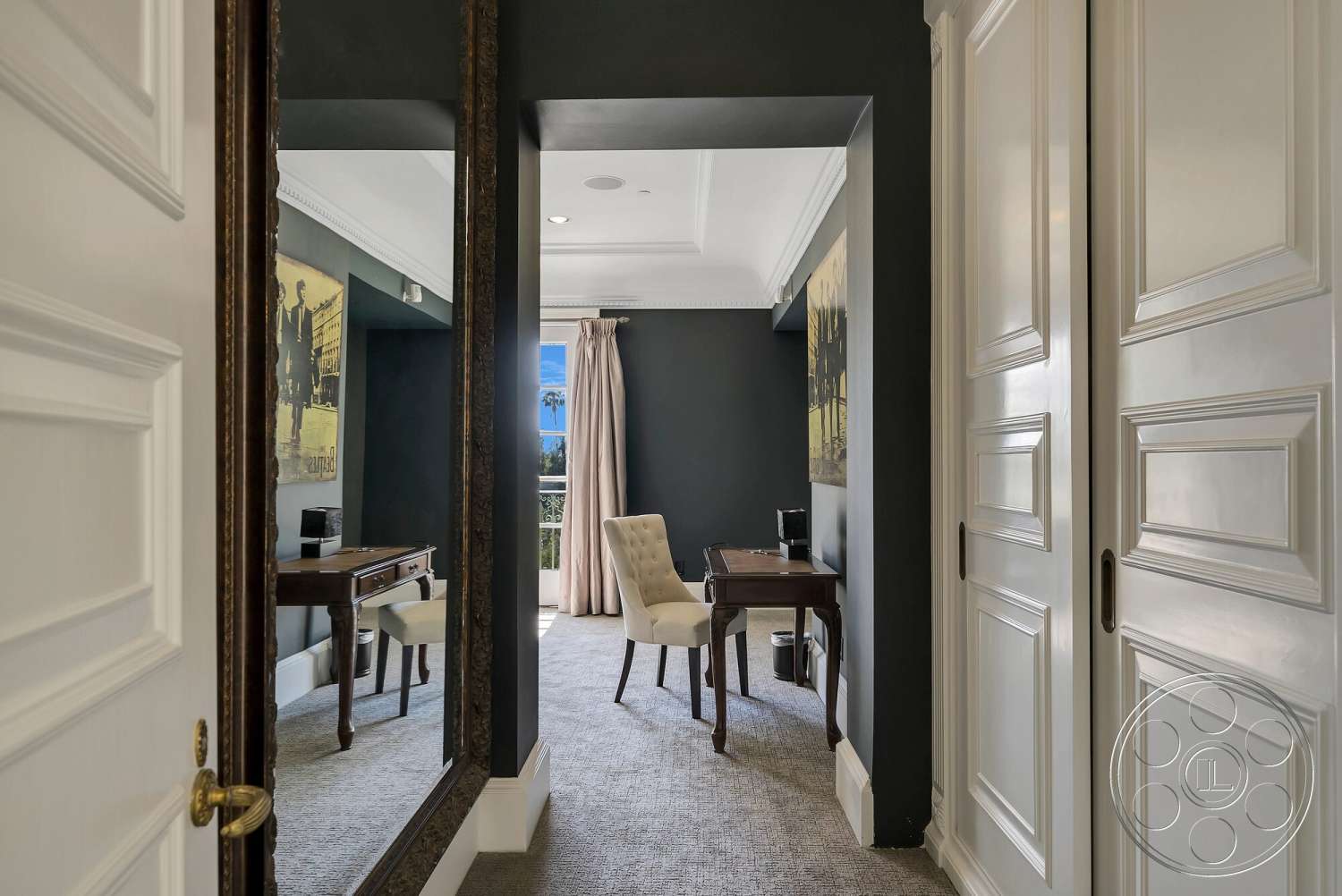 Medit 171 - upholstered chair, floor-to-ceiling window, pleated drapery, dark painted walls, crown molding details, interior office space, ornate framed mirror, white paneled door, luxury carpet flooring, classic wood desk
