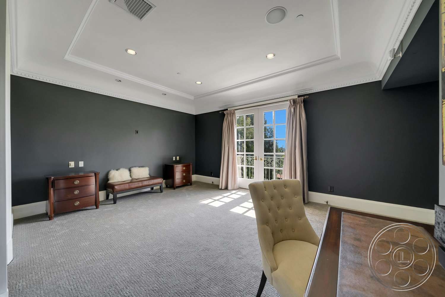 Medit 171 - neutral color palette, wooden furniture, carpet flooring, natural light from windows, double French doors, crown molding details, dark wall treatment, tufted upholstered chair, traditional style room