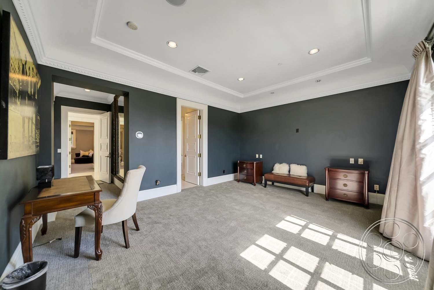 Medit 171 - coffered ceiling, wooden desk, upholstered armchair, crown molding details, gray painted walls, carpet bedroom flooring, mirror wall accent, dark wood dressers