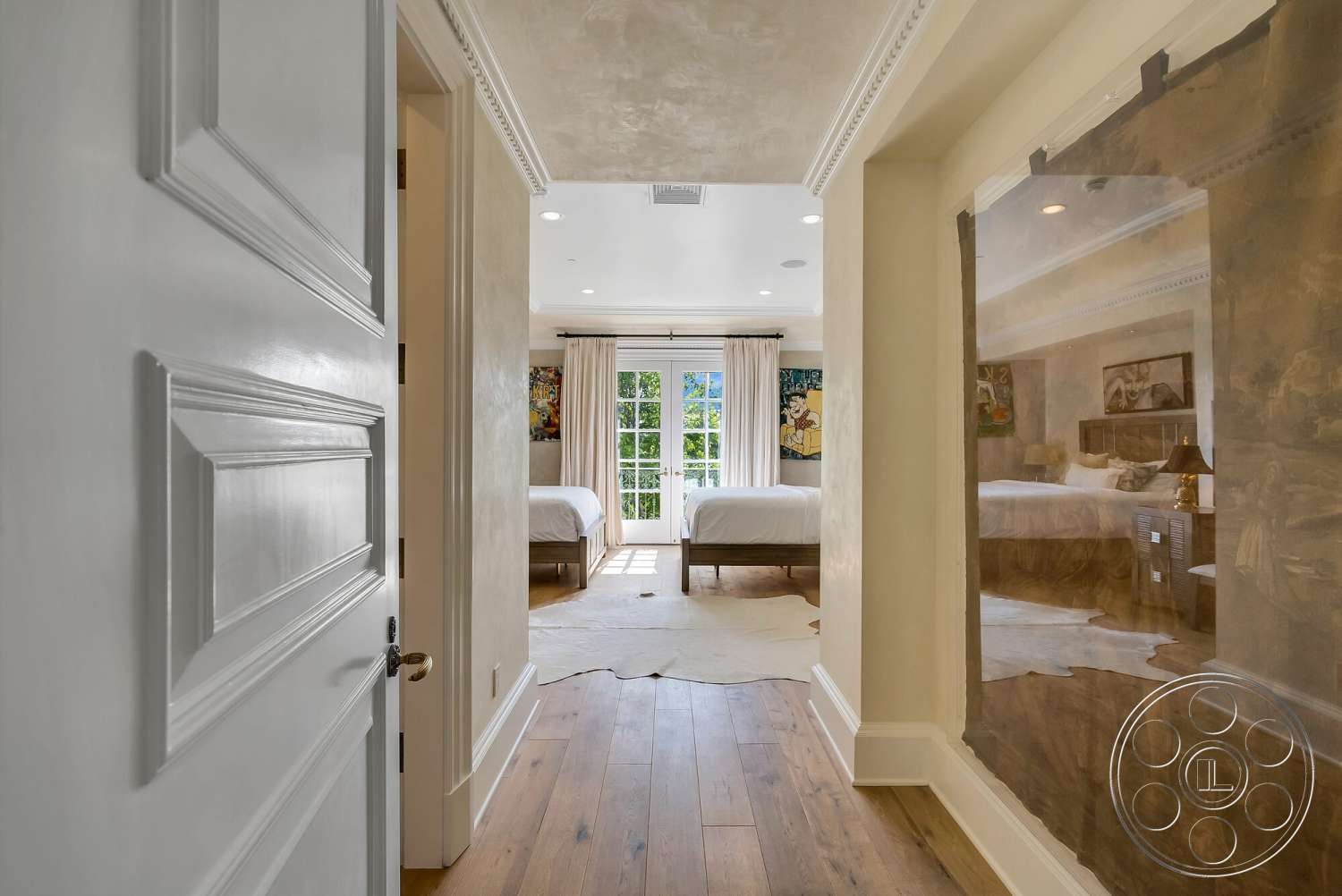 Medit 171 - natural light, hardwood flooring, artwork on walls, floor-to-ceiling windows, textured plaster walls, interior hallway, painted drywall walls, coffered ceiling details, cowhide area rug, white paneled door, master bedroom doors, drapery with floral patterns