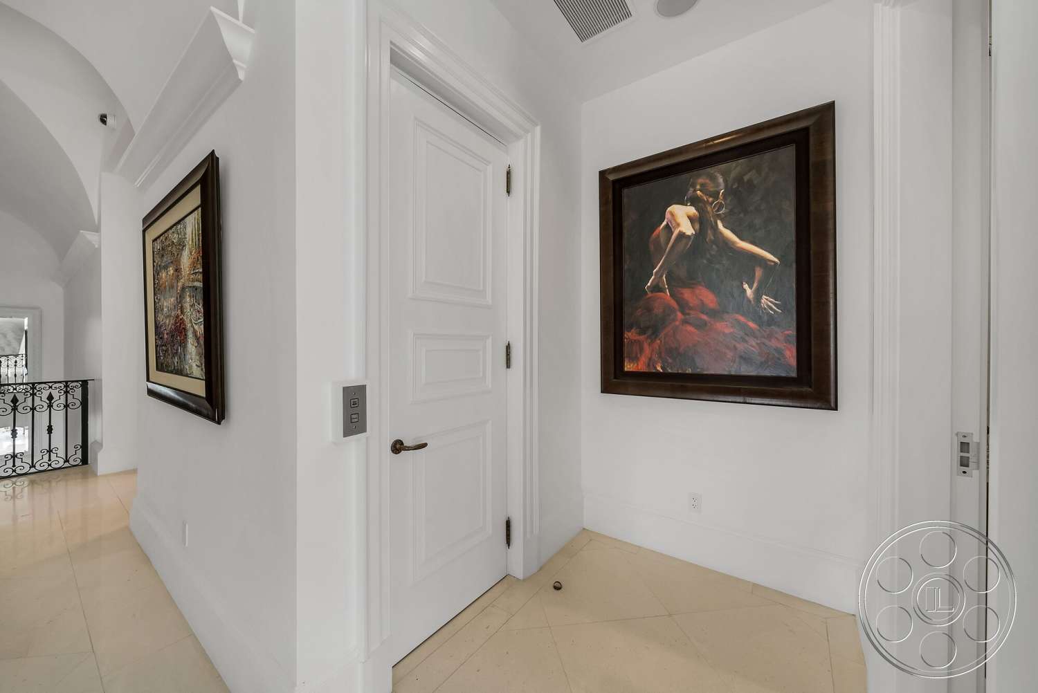 Medit 171 - framed artwork, arched doorways, recessed ceiling lights, decorative wall molding, white painted walls, black wrought iron balcony railing, cream-colored marble flooring