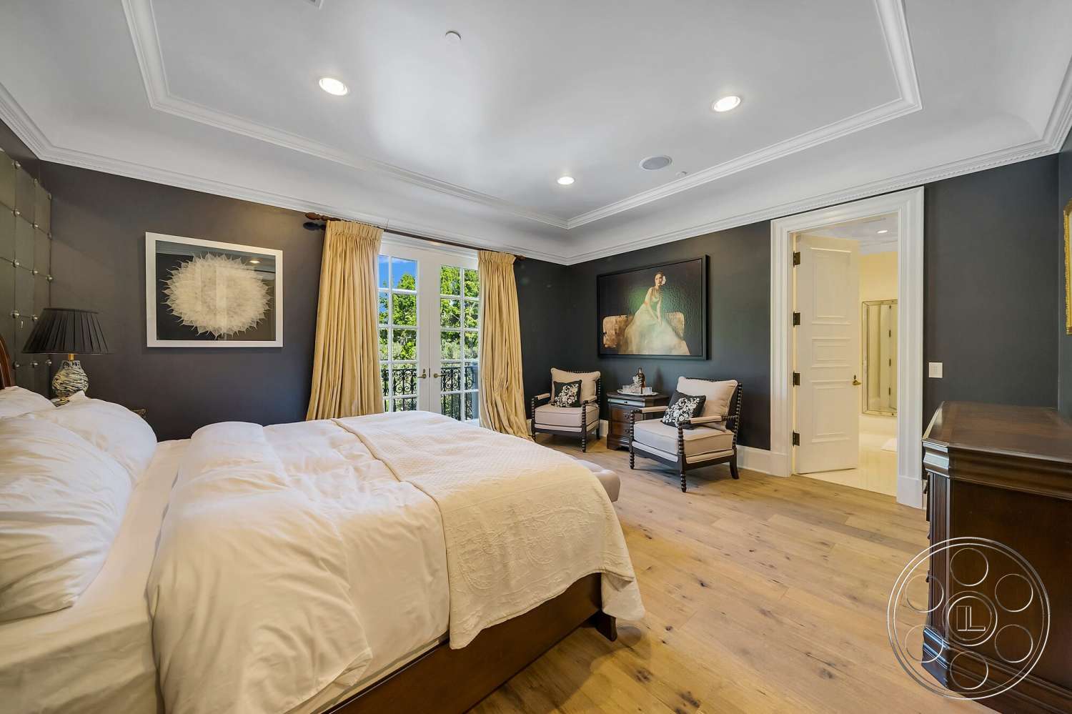 Medit 171 - master bedroom, dark wood paneling, exposed light fixtures, hardwood bedroom floors, coffered ceiling details, glass French doors, white crown molding