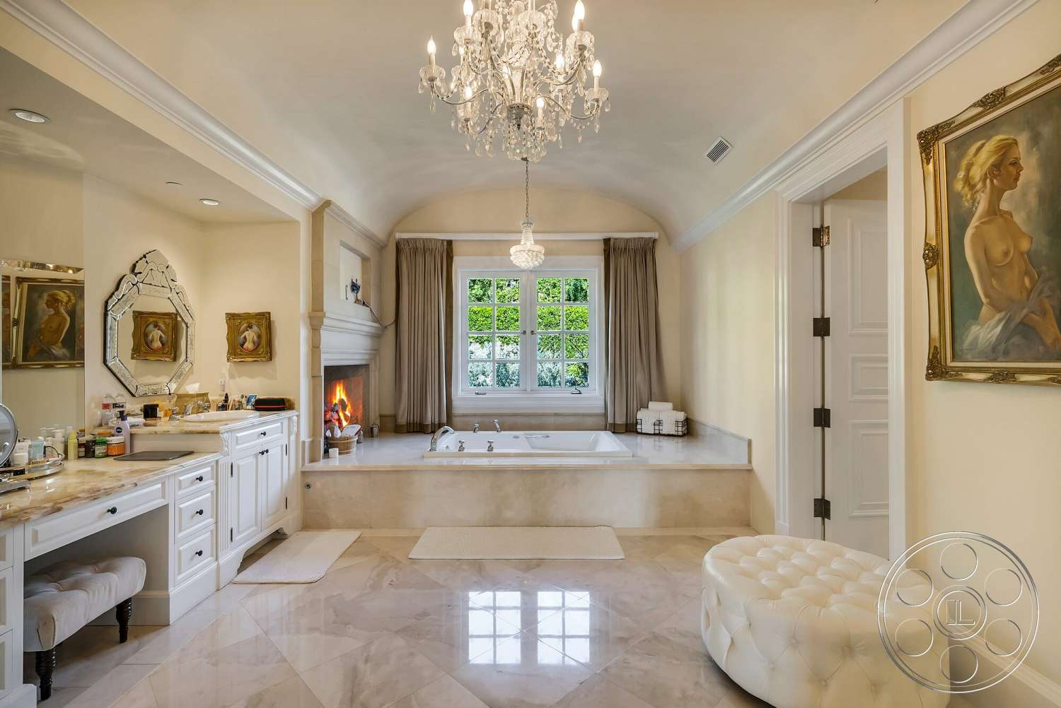 Medit 171 - artwork on walls, floor-to-ceiling windows, white cabinetry, chandelier lighting, marble flooring, arched ceiling, polished chrome fixtures, white painted walls, soft fabric curtains, plush upholstered ottoman, vanity with marble countertop, luxurious bathroom interior, stone bathtub surround, fireplace with mantel