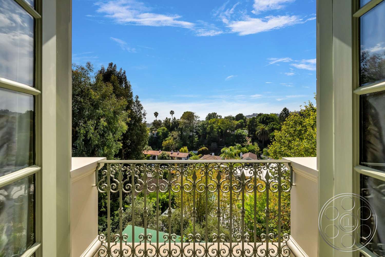 Medit 171 - exterior, balcony with wrought iron railing, view of lush greenery, sunny sky with blue tones, residential neighborhood landscape