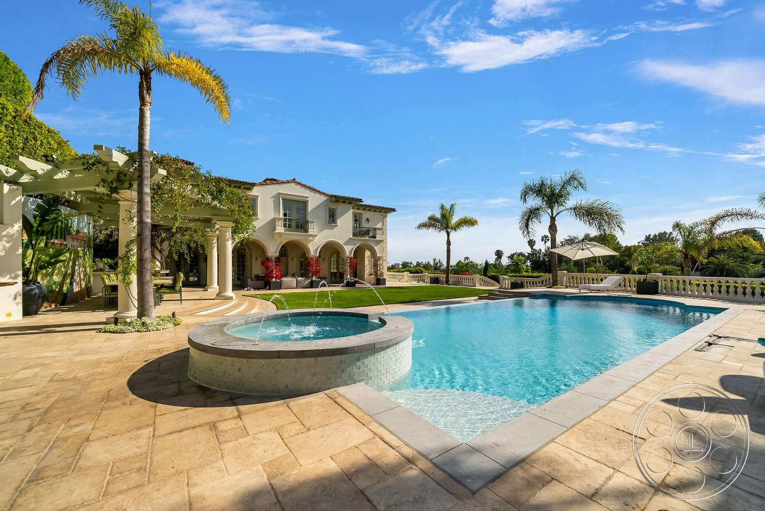 Medit 171 - exterior, palm trees, rectangular swimming pool, poolside lounge chairs, arched doorways, lush tropical landscaping, tile roof, garden area, wood pergola structure, concrete patio floor, stucco home facade, natural stone coping, paver stone pool deck, blue sky view, integrated spa, decorative pool railing