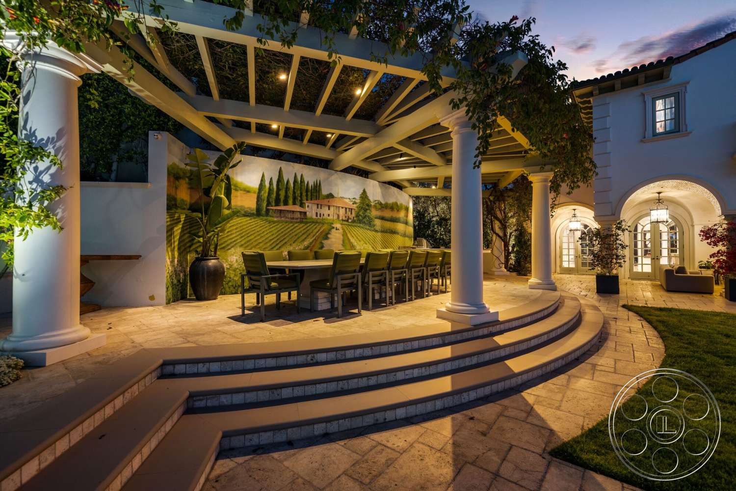 Medit 171 - exterior, landscaped garden, outdoor dining area, concrete steps, arched doorway, suburban backyard, exposed wood ceiling beams, stone patio flooring, stainless steel outdoor furniture, painted wall mural, columned pergola